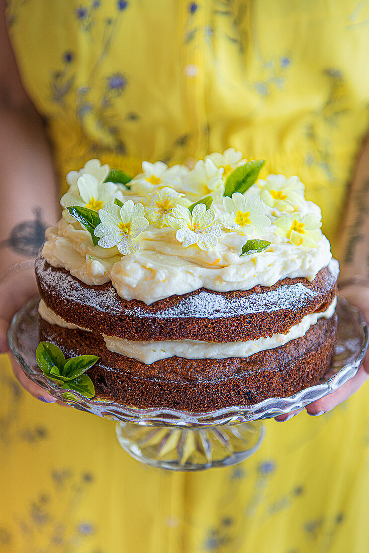 Carrot cake with cream cheese icing and edible flowers