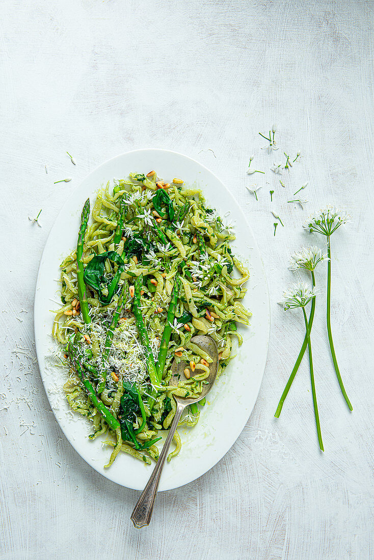 Spring trofie handmade pasta with wild garlic, asparagus, pine nuts and parmesan cheese