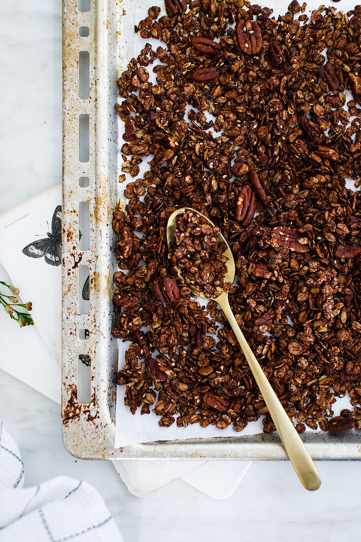 Espresso and chocolate granola on a baking tray