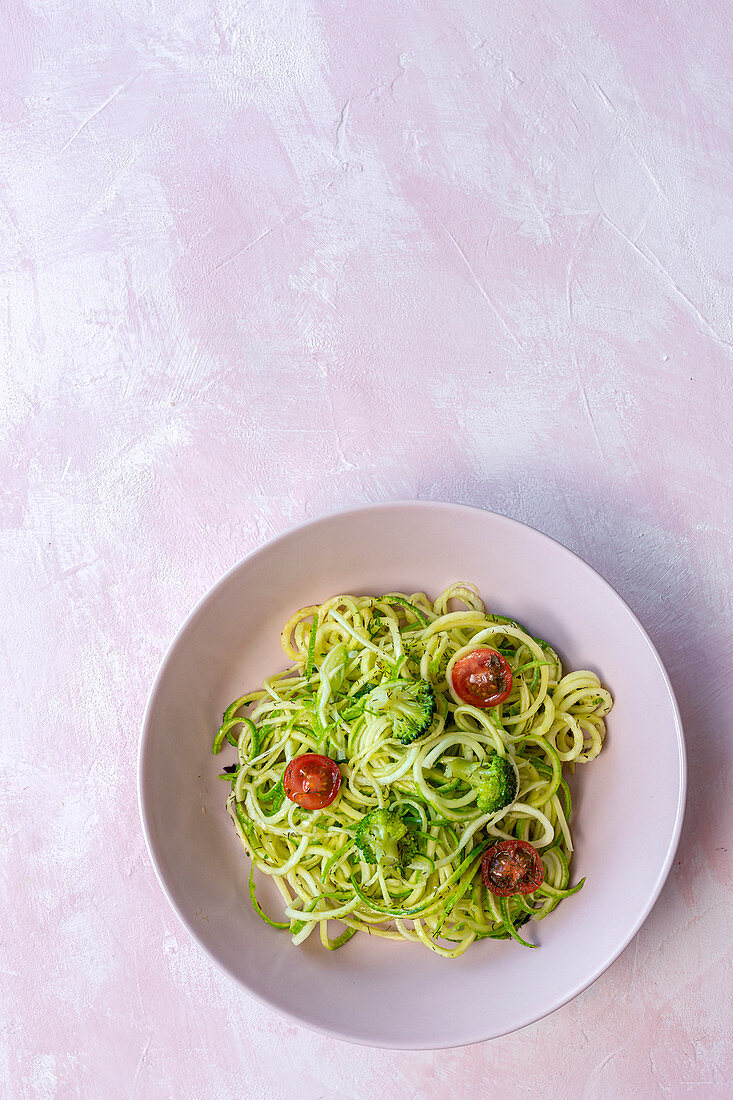 Homemade Zucchini Spaghetti with pesto sauce, broccoli and cherry tomatoes