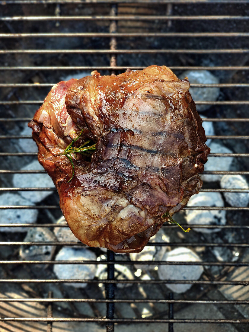 Grilled leg of lamb on a grill rack