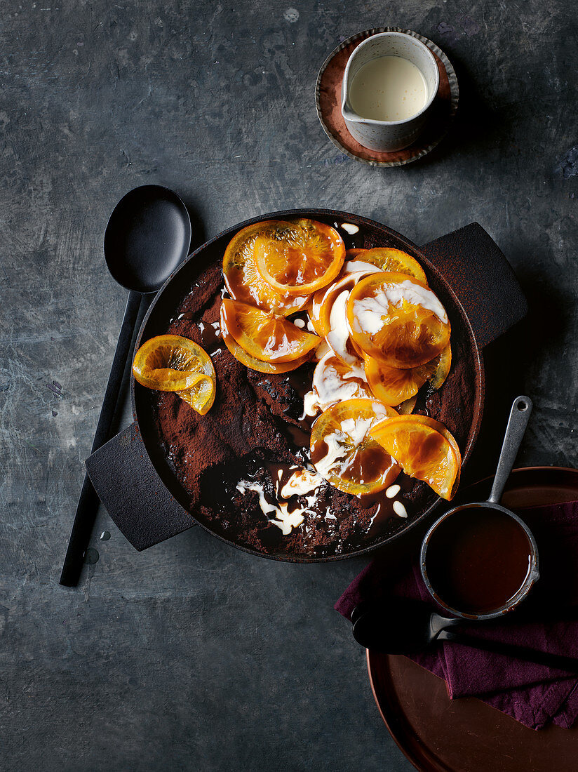 Double-saucing butterscotch chocolate orange pudding