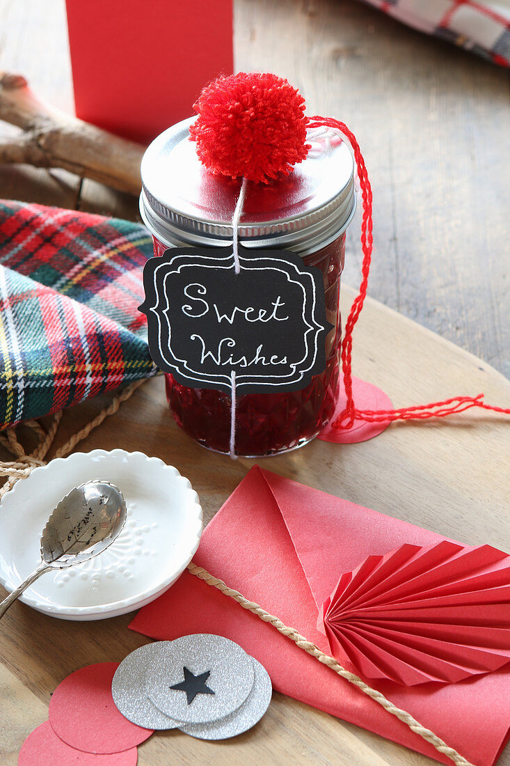 Culinary gift in screw-top jar with label and red decorations