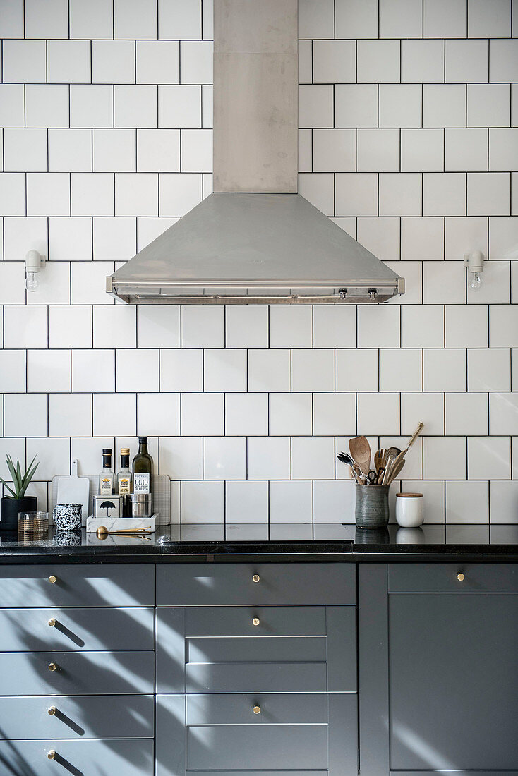 Extractor hood above classic kitchen unit with grey cupboards