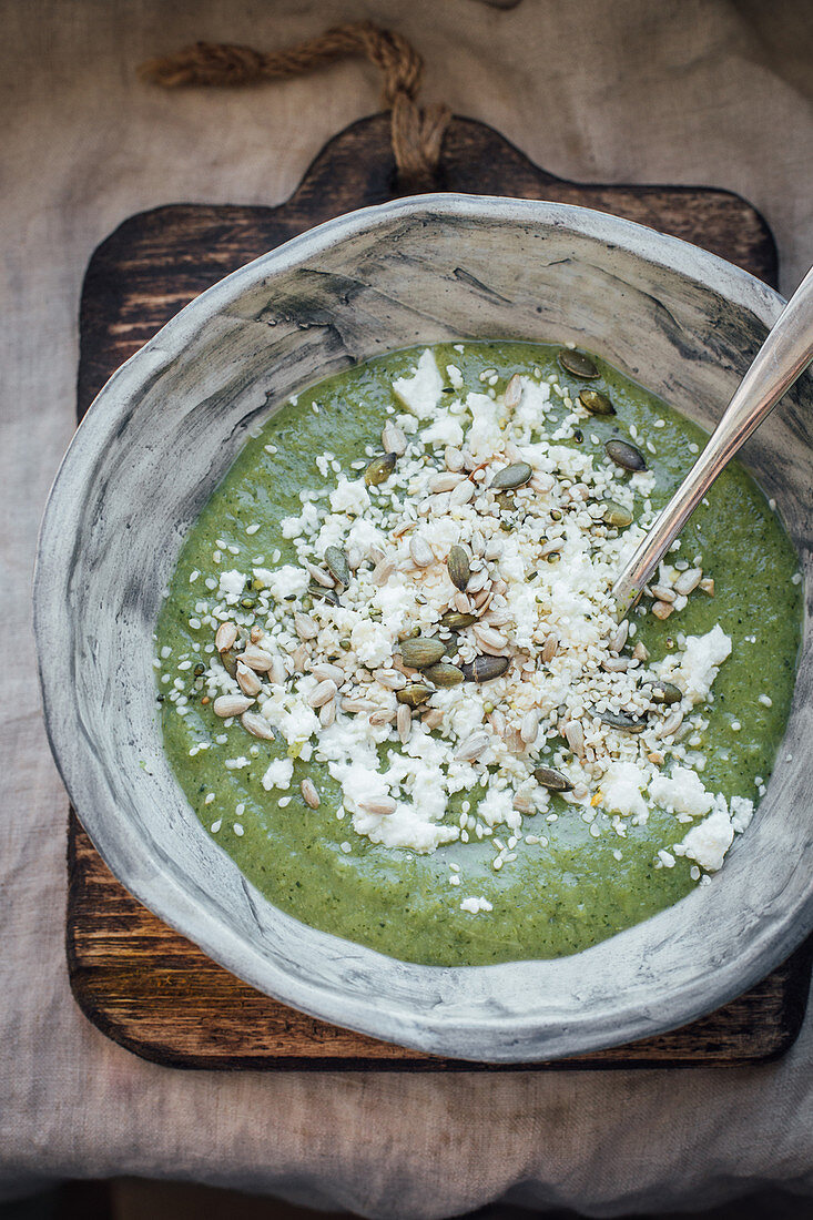 Cream of broccoli soup with feta cheese and roasted sunflower seeds and pumpkin seeds