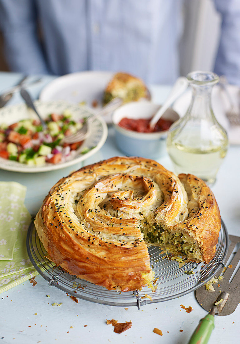 Veggie spiral pie with spiced tomato sauce and chopped salad