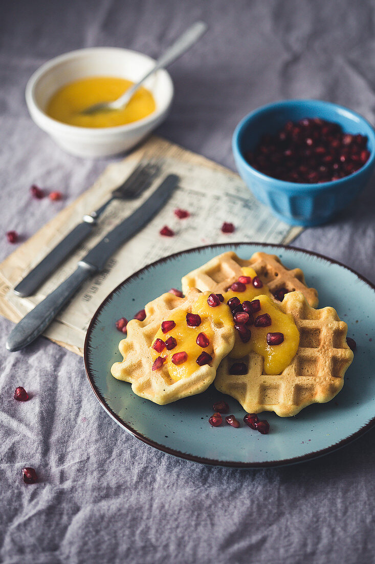 Waffles with mango mousse and pomegranate seeds