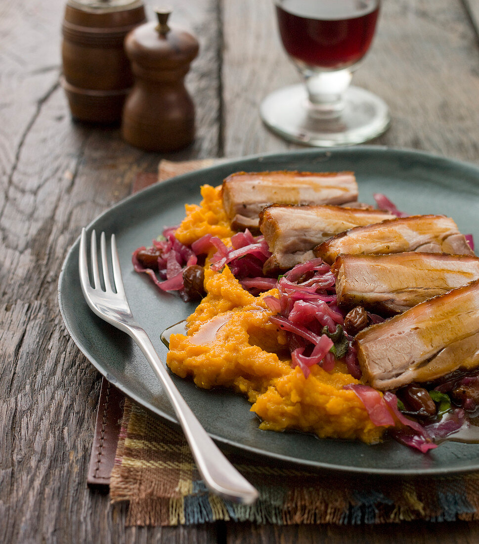 Pork belly on a bed of sweet potato mash, red cabbage with gravy