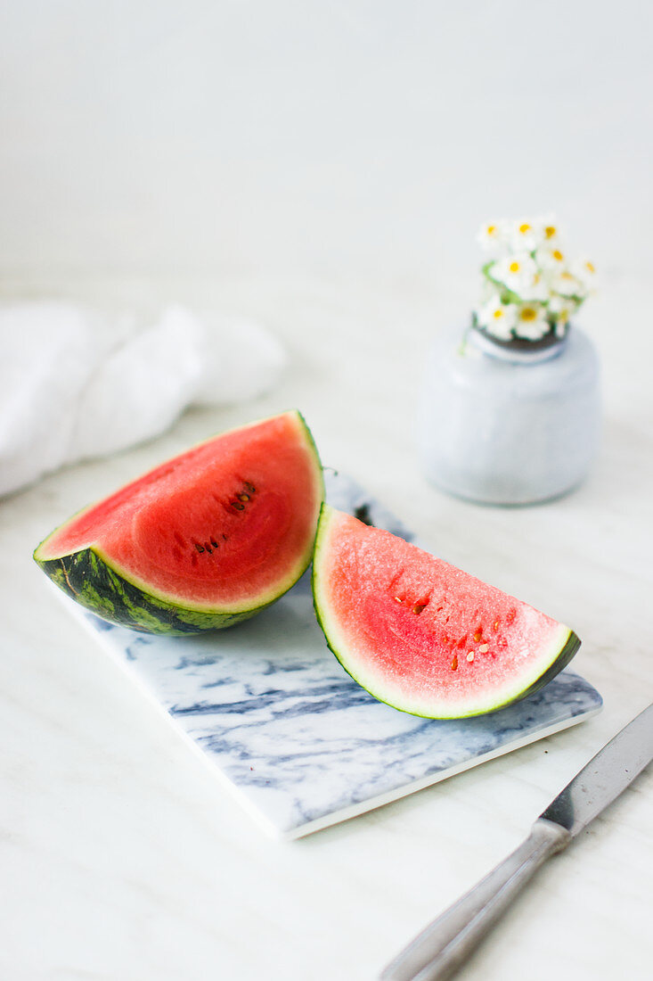 Watermelon wedges on a marble chopping board