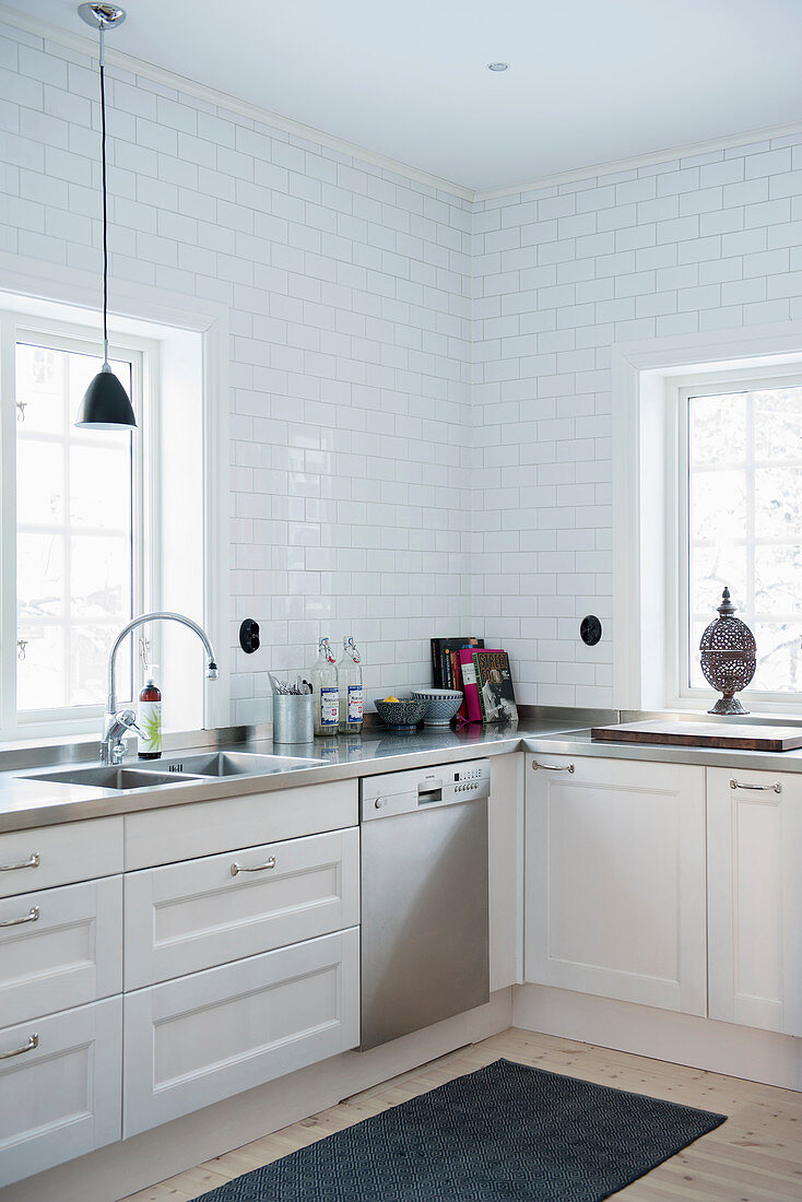 White kitchen with panelled fronts and lattice windows