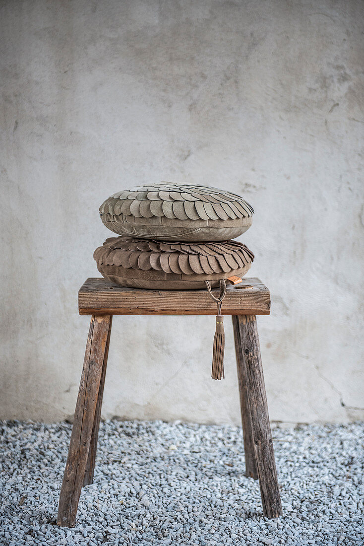 Suede cushions on wooden stool