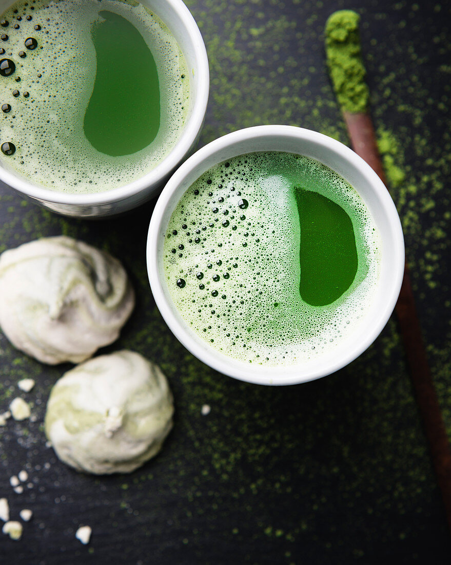 Two cups of matche tea with vegan meringues