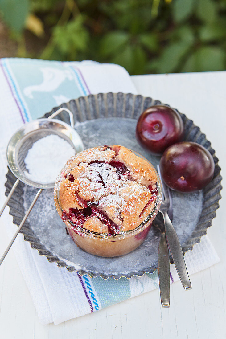 Plum cake baked in a glass with icing sugar