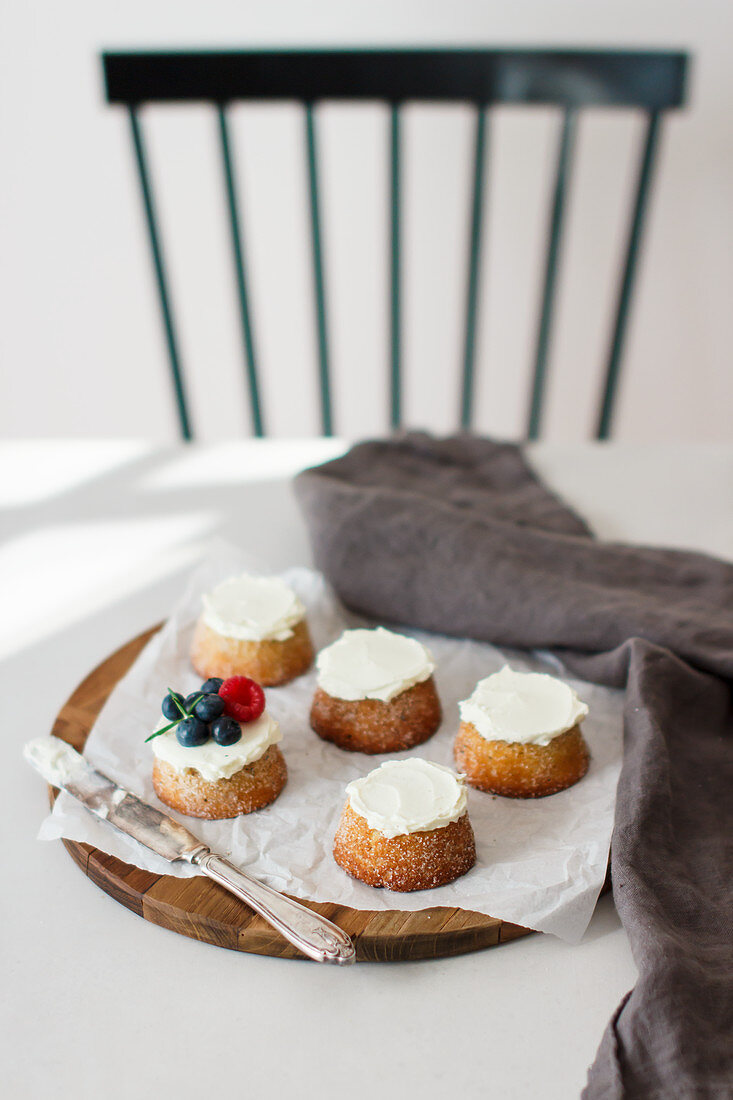 Cardamom and marzipan cakes topped with cream and berries