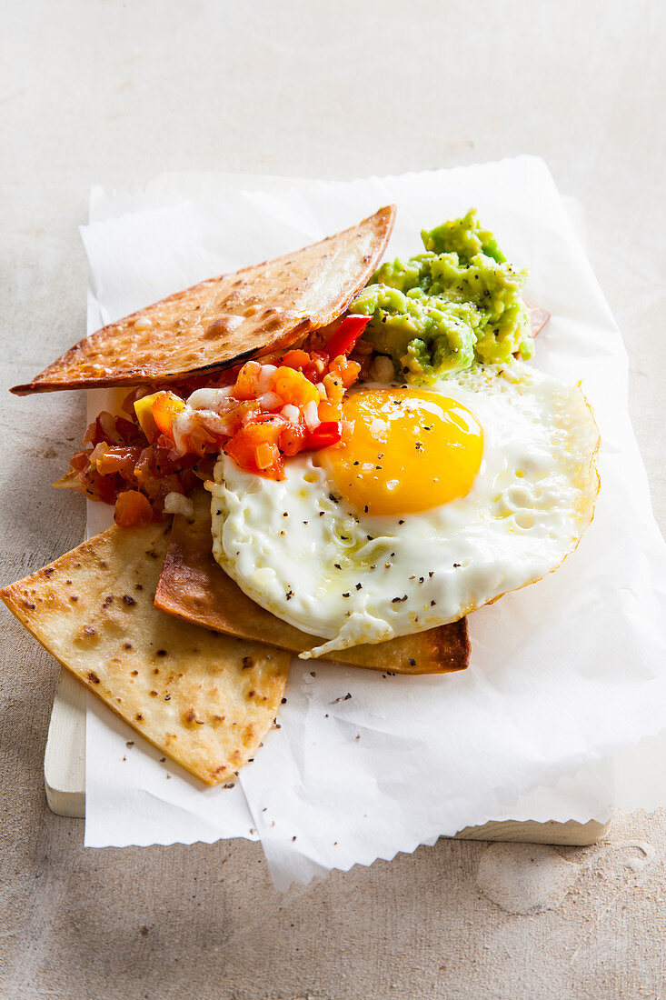 Chilaquiles fried tortillas with avocado cream