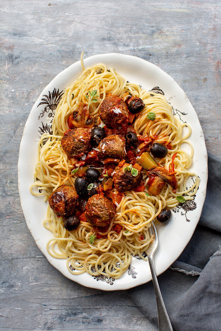 Spaghetti with Italian meatballs in olive tomato sauce