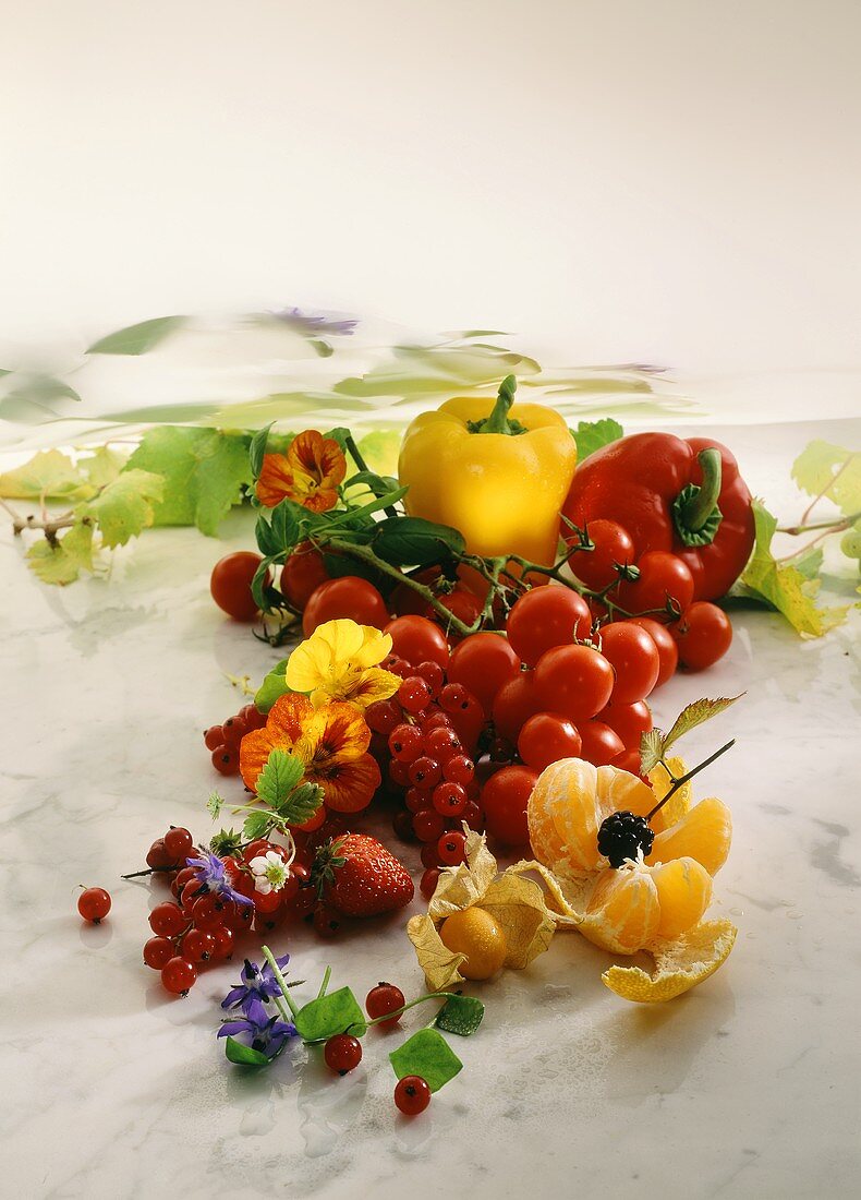 Various berries, fruit and vegetables on marble