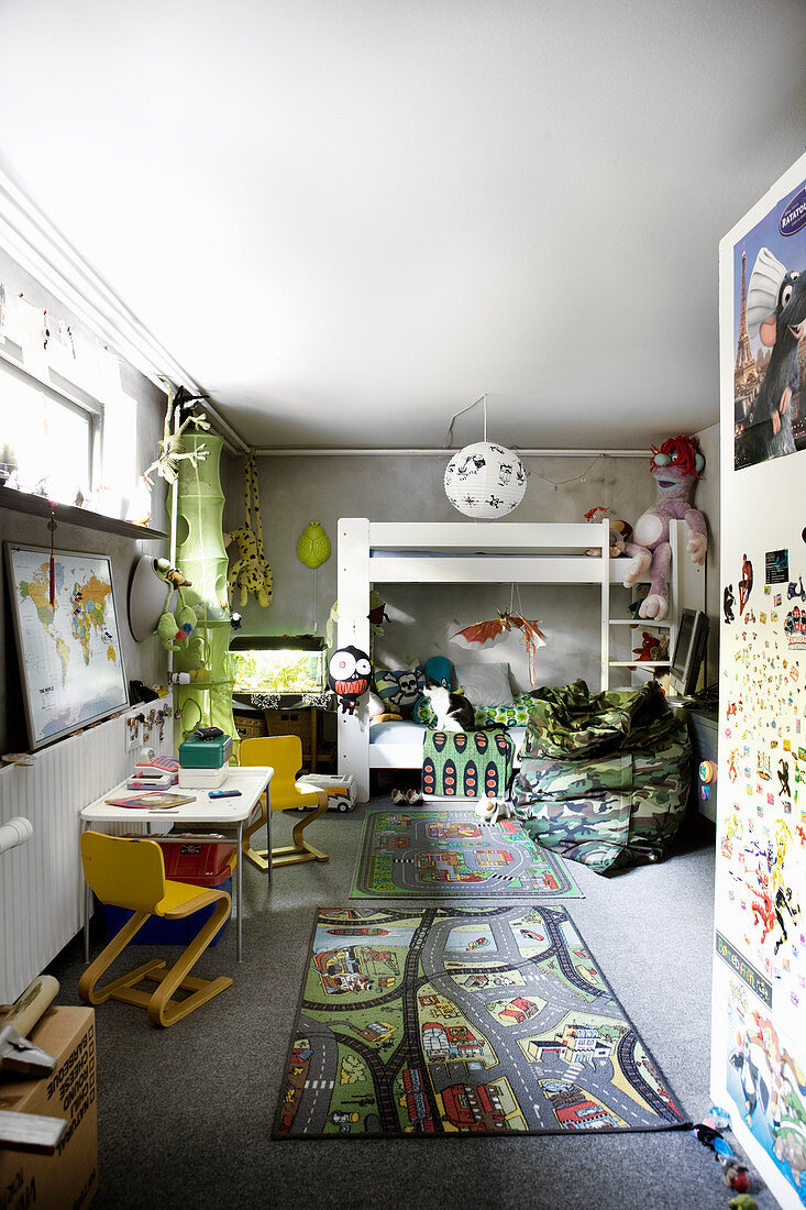 Loft bed and play rug in child's bedroom in semi-basement