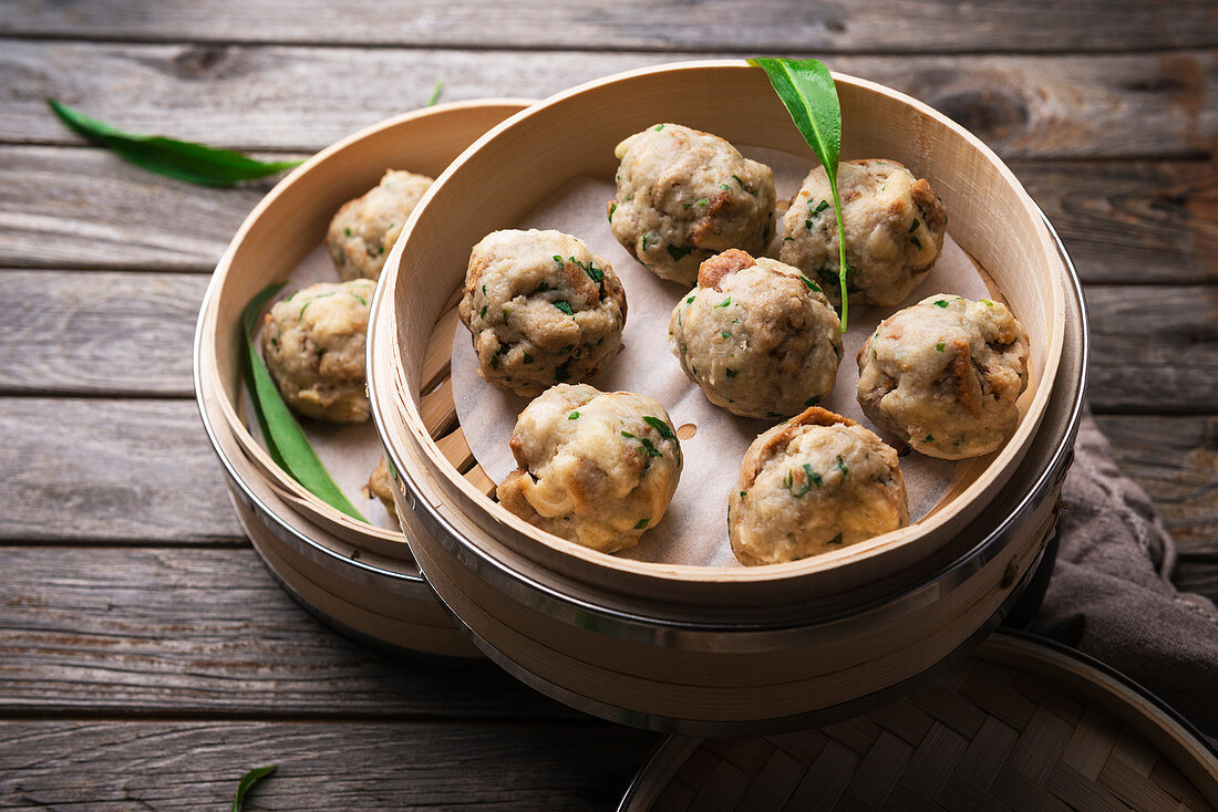 Vegan wild garlic bread dumplings made in a bamboo steamer