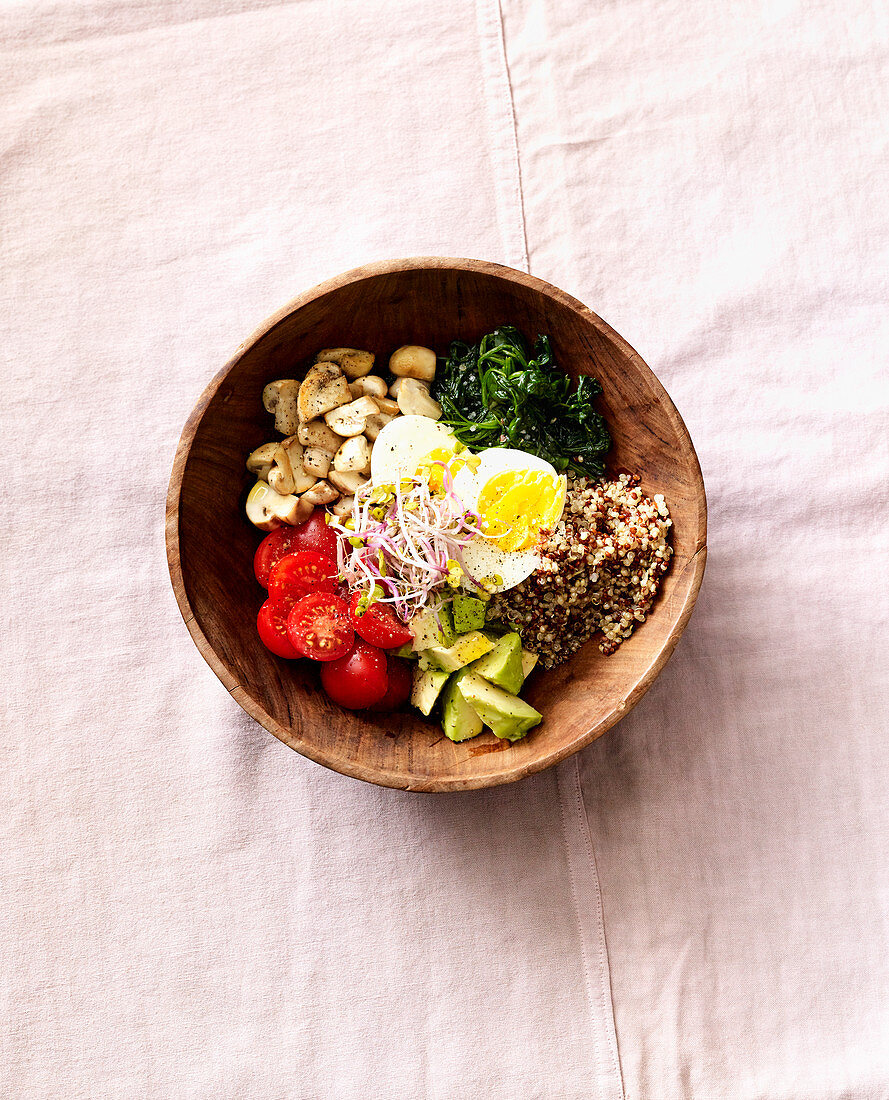 A savoury breakfast bowl with quinoa, egg and bean sprouts