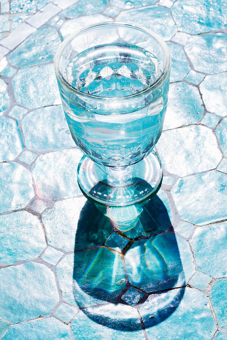 A glass of water on a tiled floor