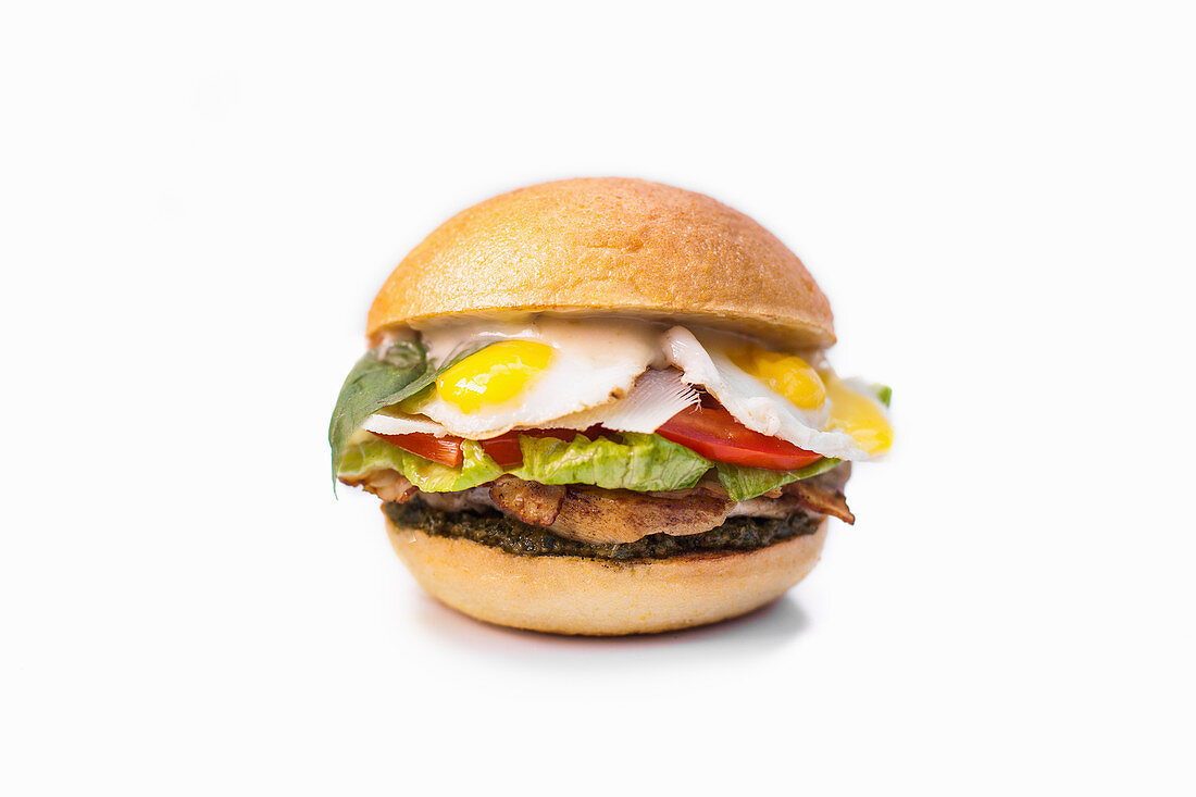 A chicken burger with fried quail's eggs