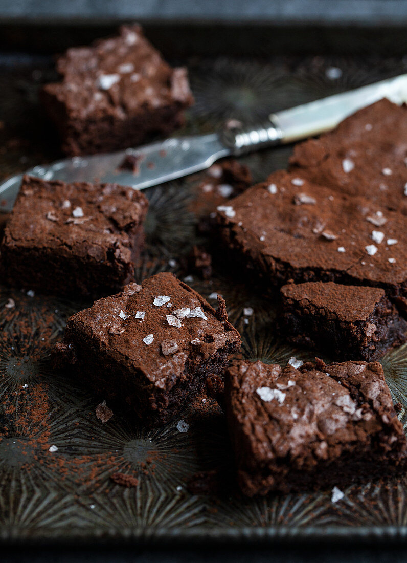 Chocolate brownies dusted with cocoa powder and sprinkled with sea salt