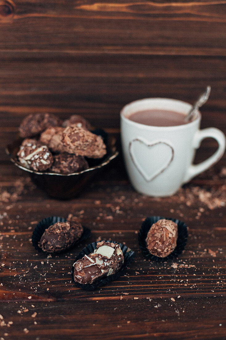 Homemade chocolate pralines with a mug of cocoa