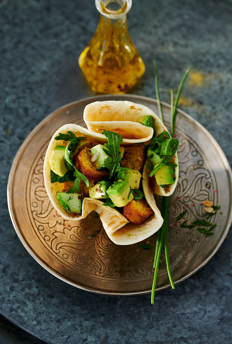 Falafel with an avocado salad in a wrap basket