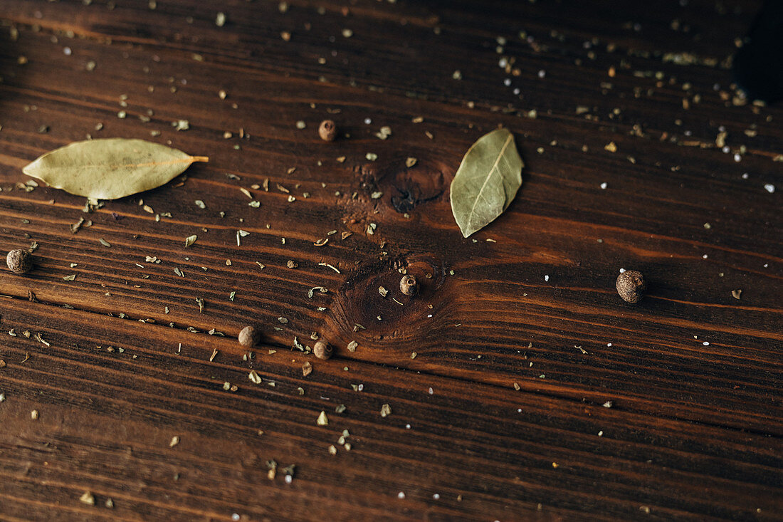 Spices sprinkled on a wooden surface