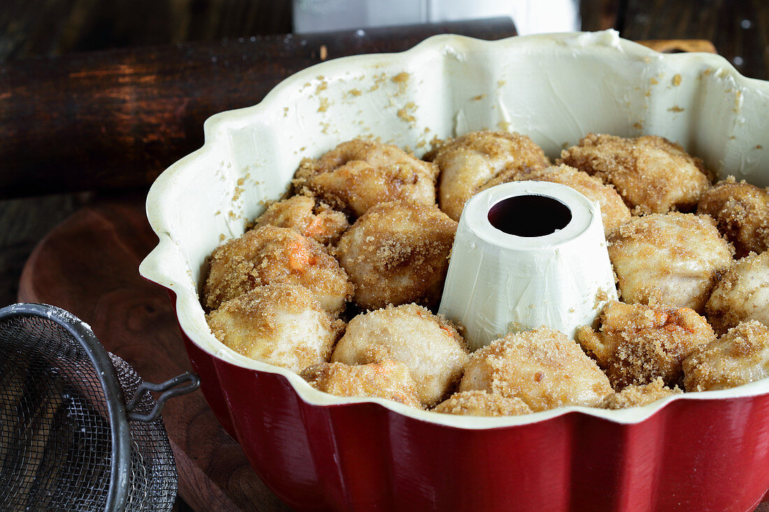 Bundt pan of sugar coated carrot monkey bread for baking