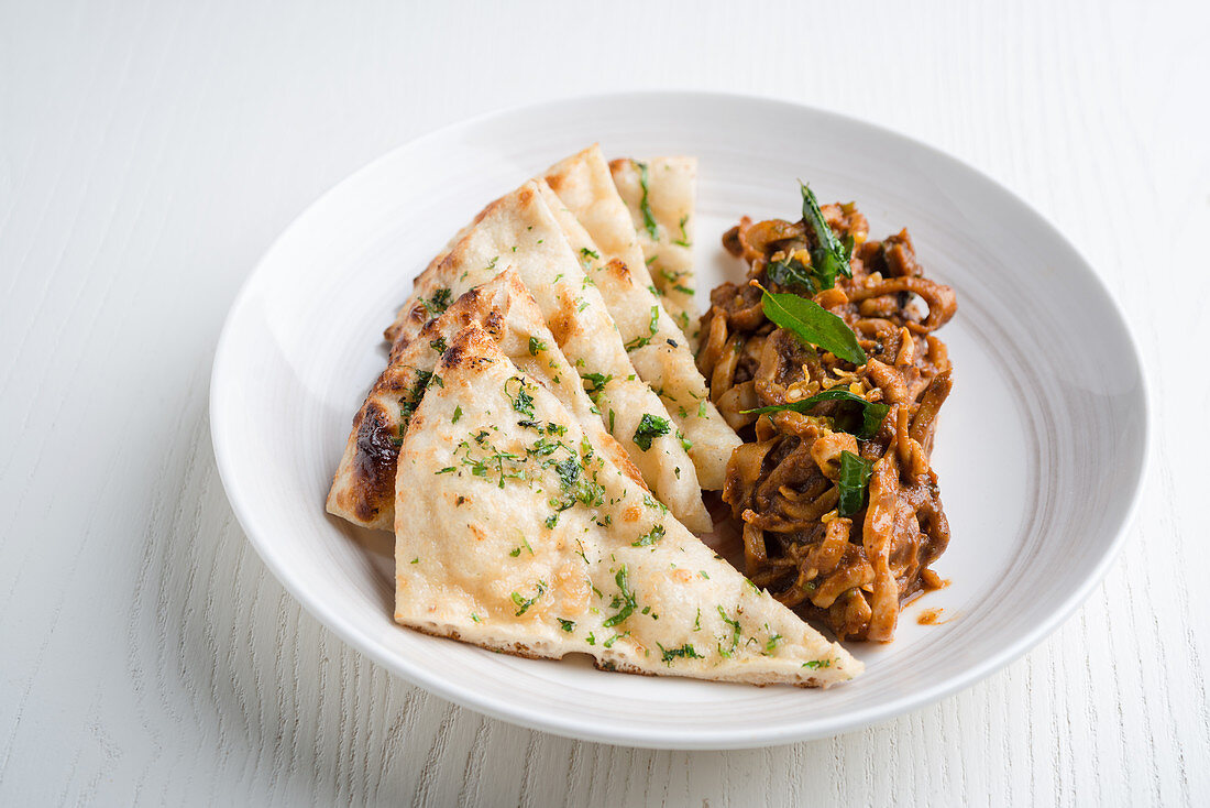 Stir fried squid with Indian bread (India)