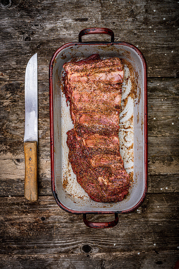 Marinated beef ribs in a roasting tin