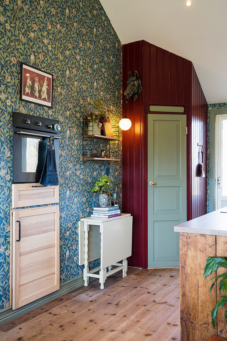 Pantry in corner of country-house kitchen with floral wallpaper