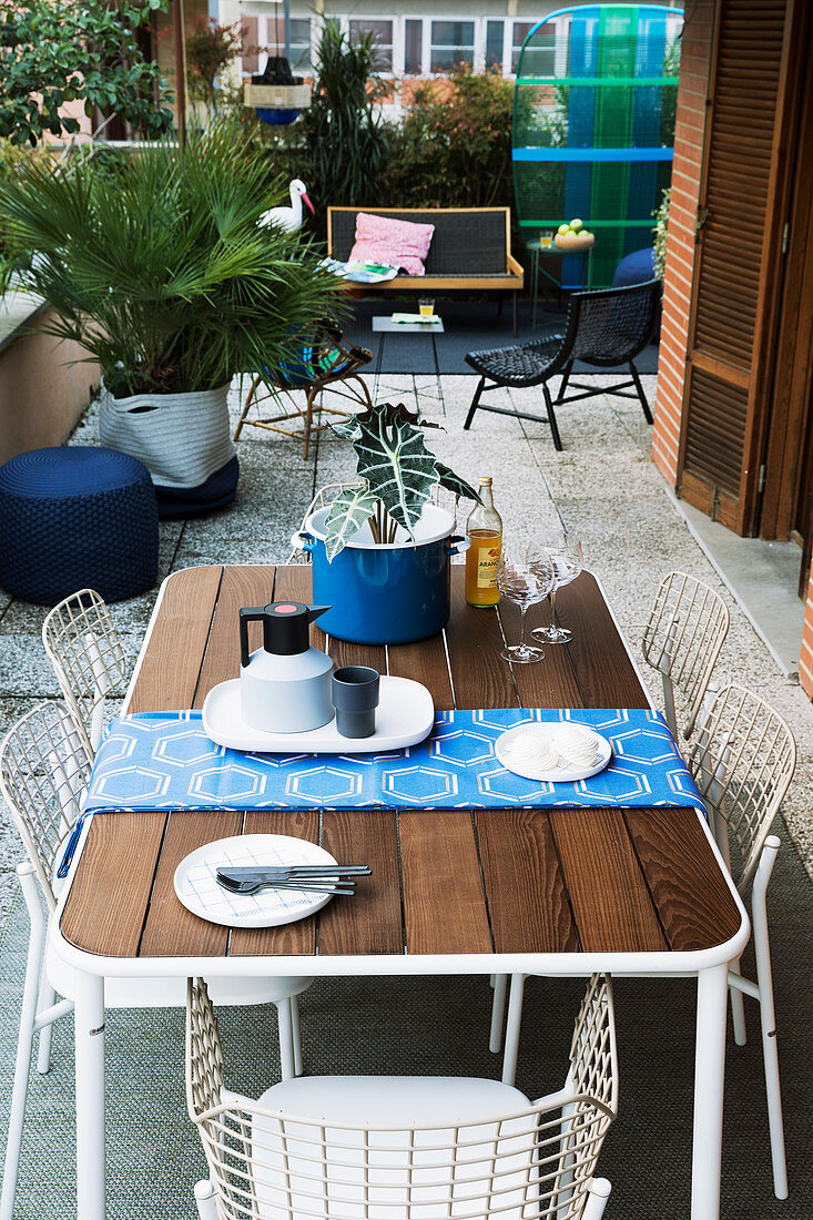 Modern table and white chairs on urban balcony