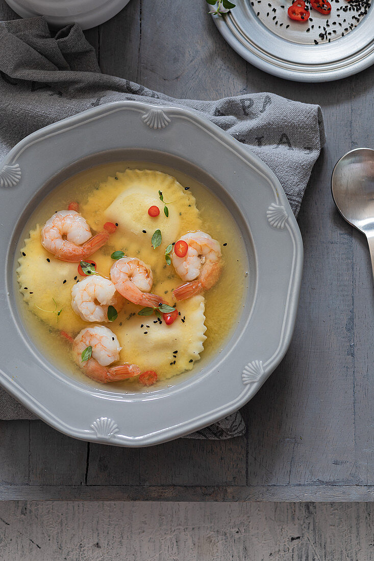 Saffron broth with ravioli and shrimp