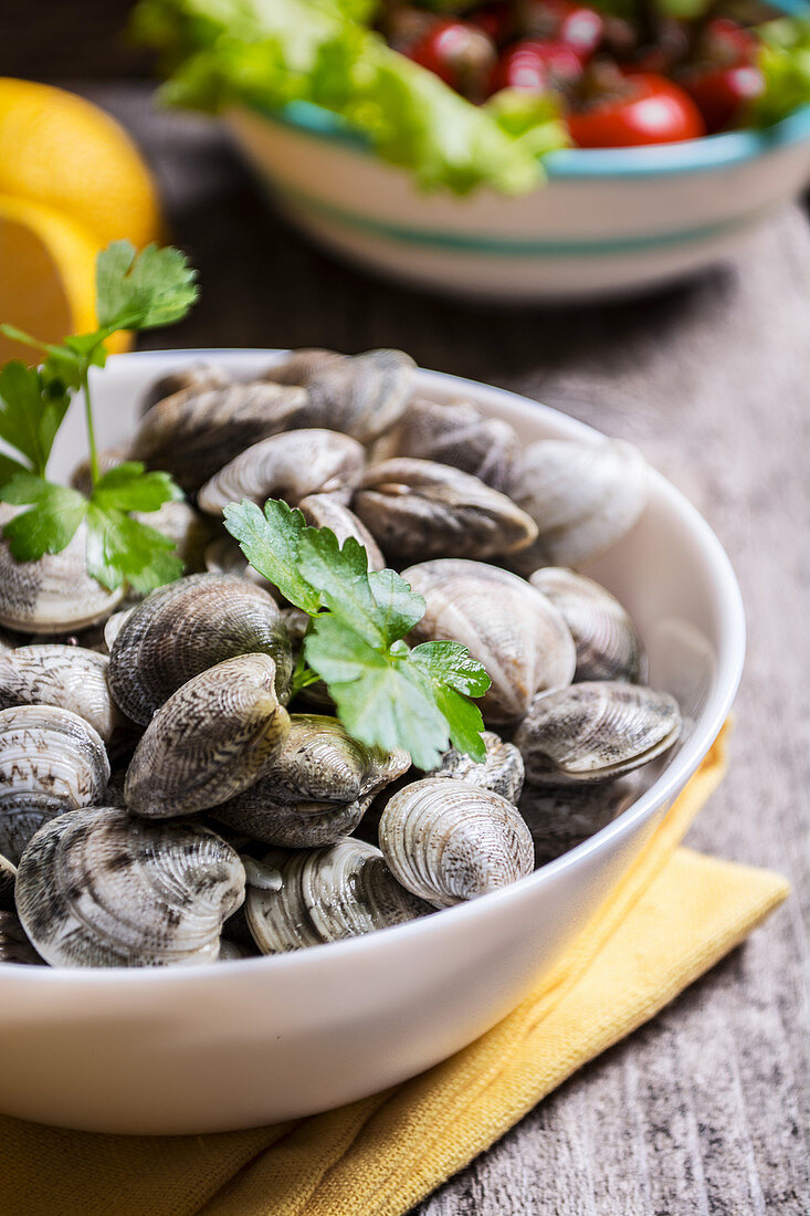 A dish of clams on the table ready to cook