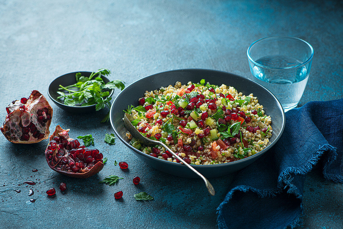 Tabouli salad with bulgur wheat, tomatoes, cucumber, pomegranate, mint and parsley