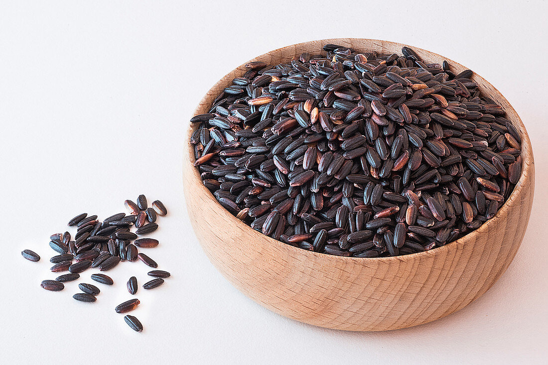 Black venere rice in a wooden bowl on
