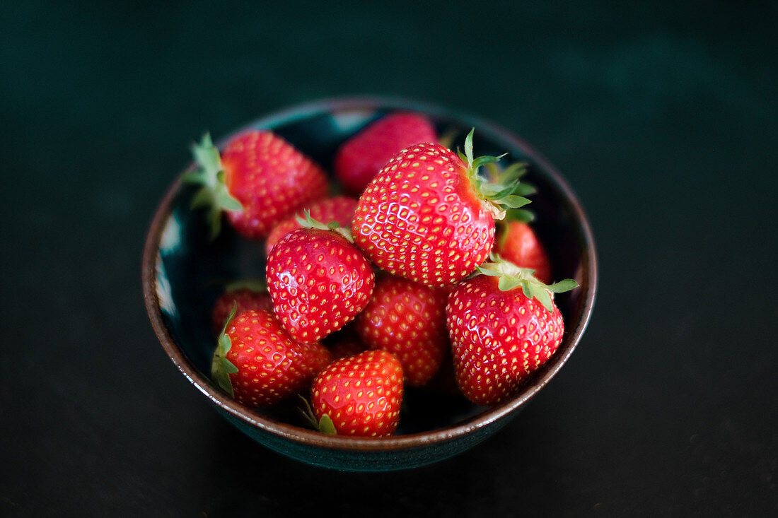 Fresh strawberries in a small dish