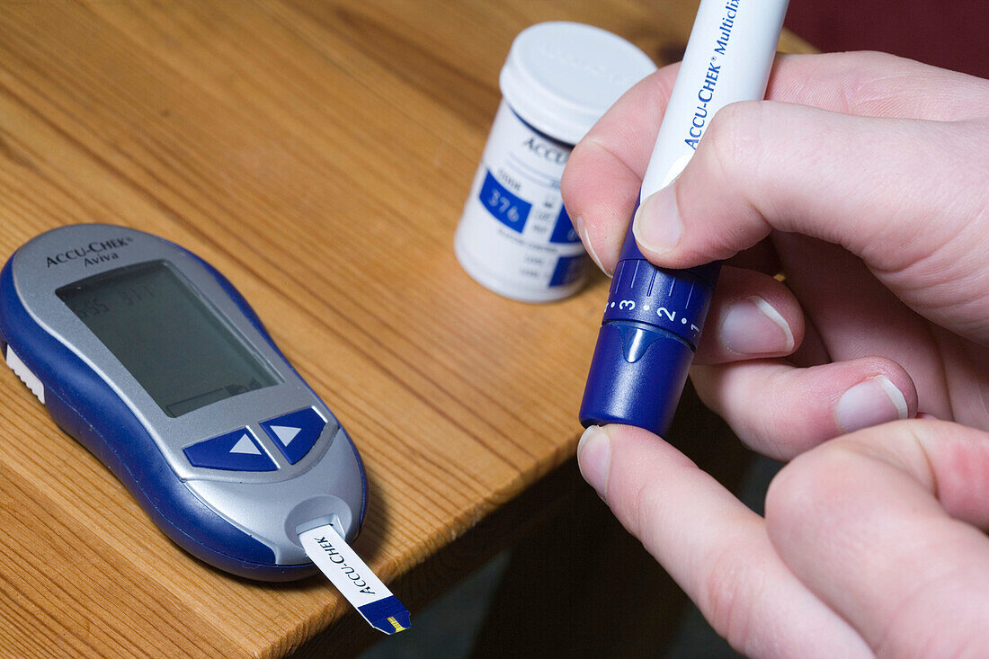 Man using a Accucheck monitor for Diabetes