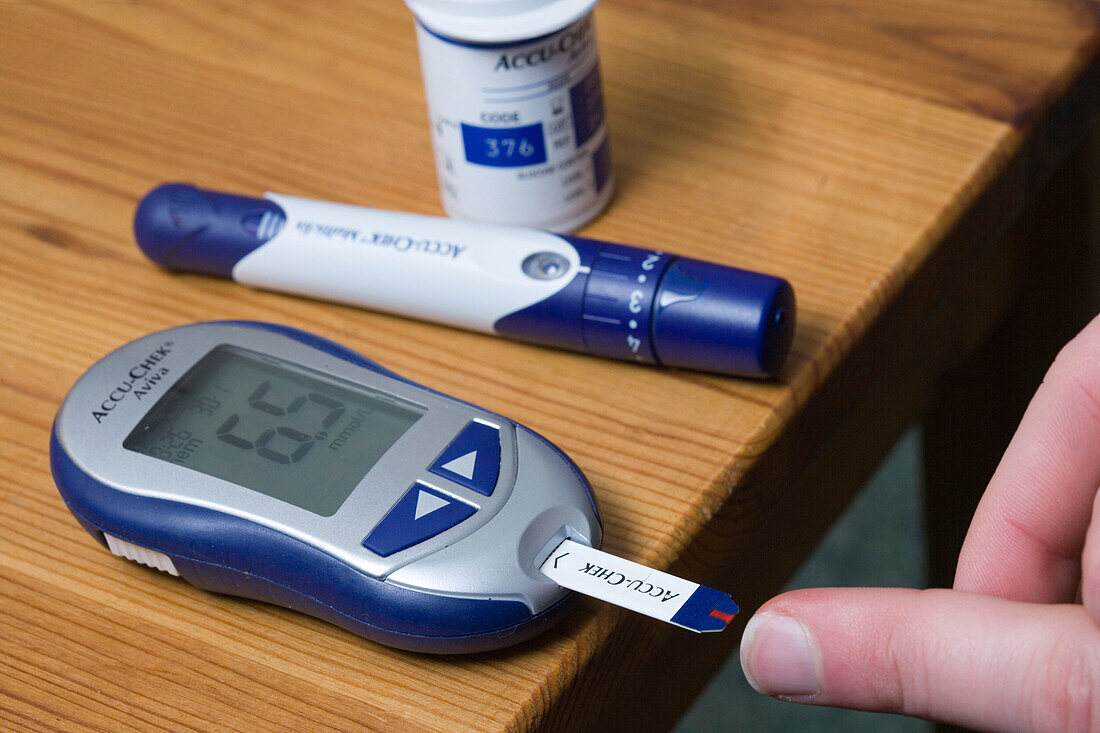 Man using a Accucheck monitor for Diabetes