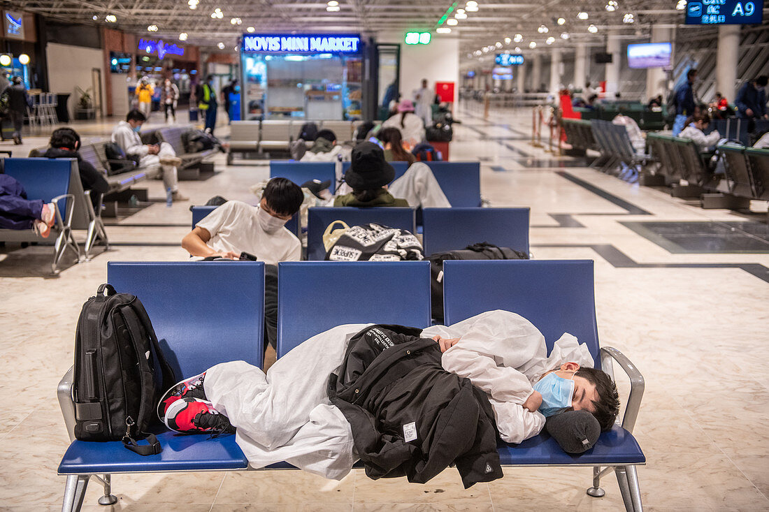 Travellers waiting in airport during Covid-19 outbreak