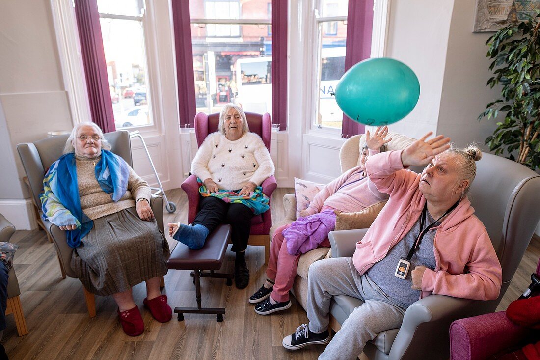 Care home residents in communal activity session