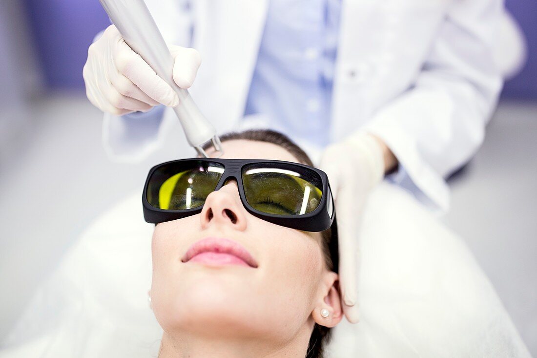 Beauty technician using laser treatment