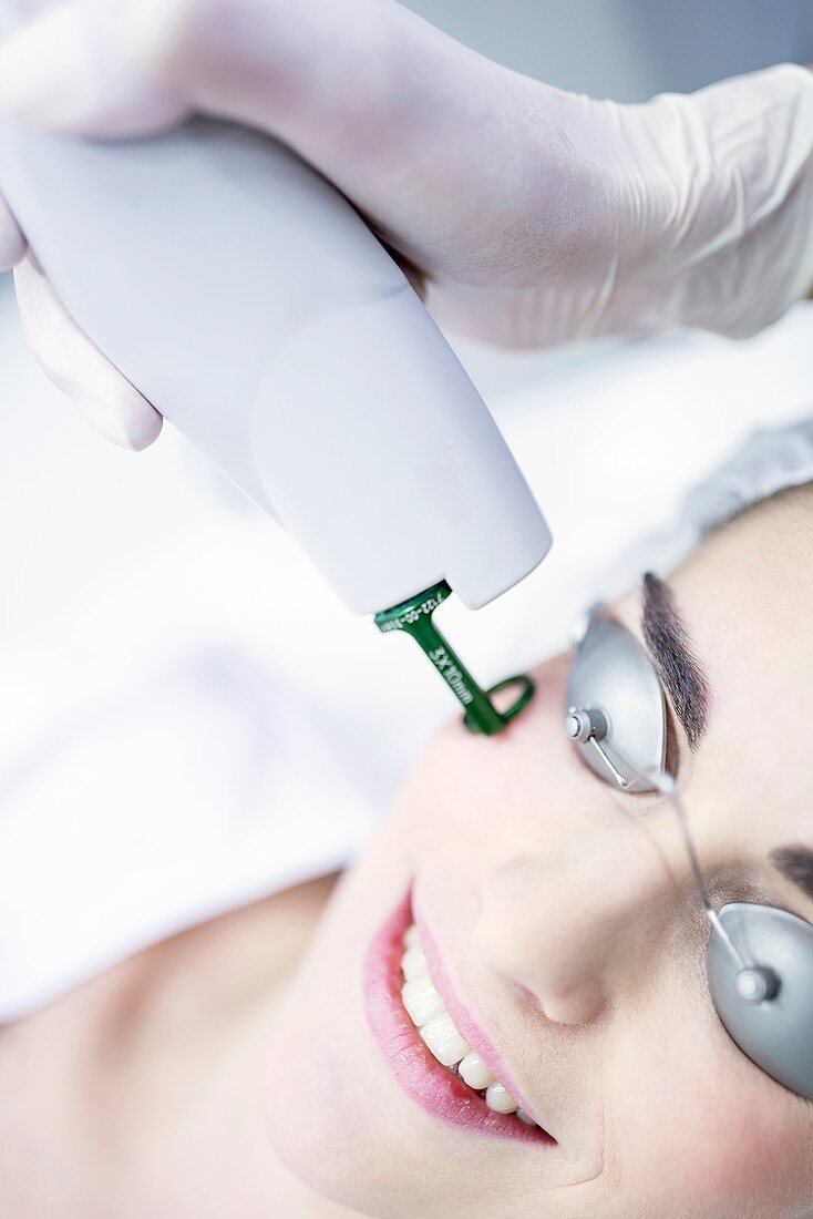 Dermatologist using laser machine