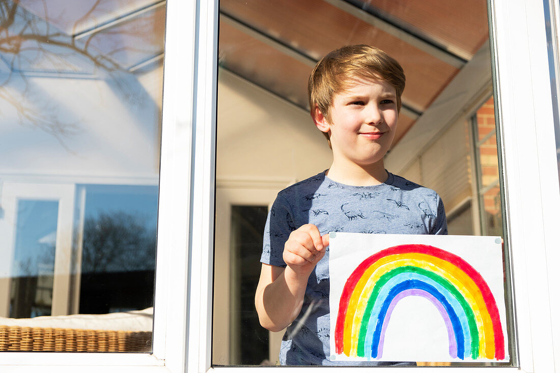 Boy holding an image of a rainbow