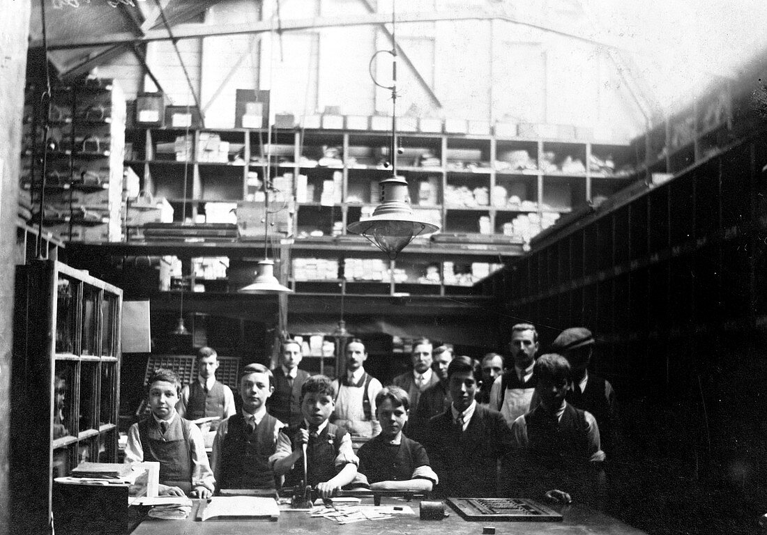 Men and boys in a printing workshop