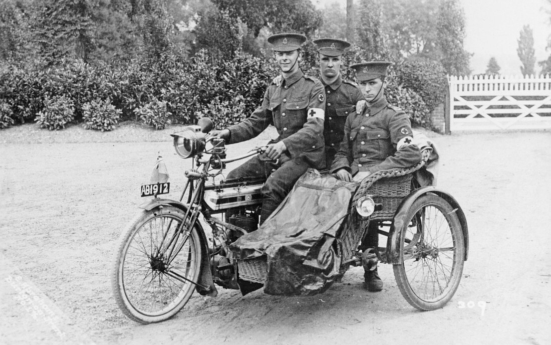Three soldiers on a bicycle and sidecar