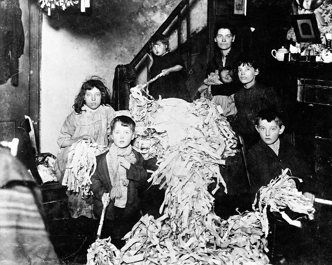 Making party streamers at home, London, c1900